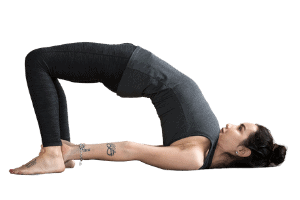 Woman in bridge yoga pose asana